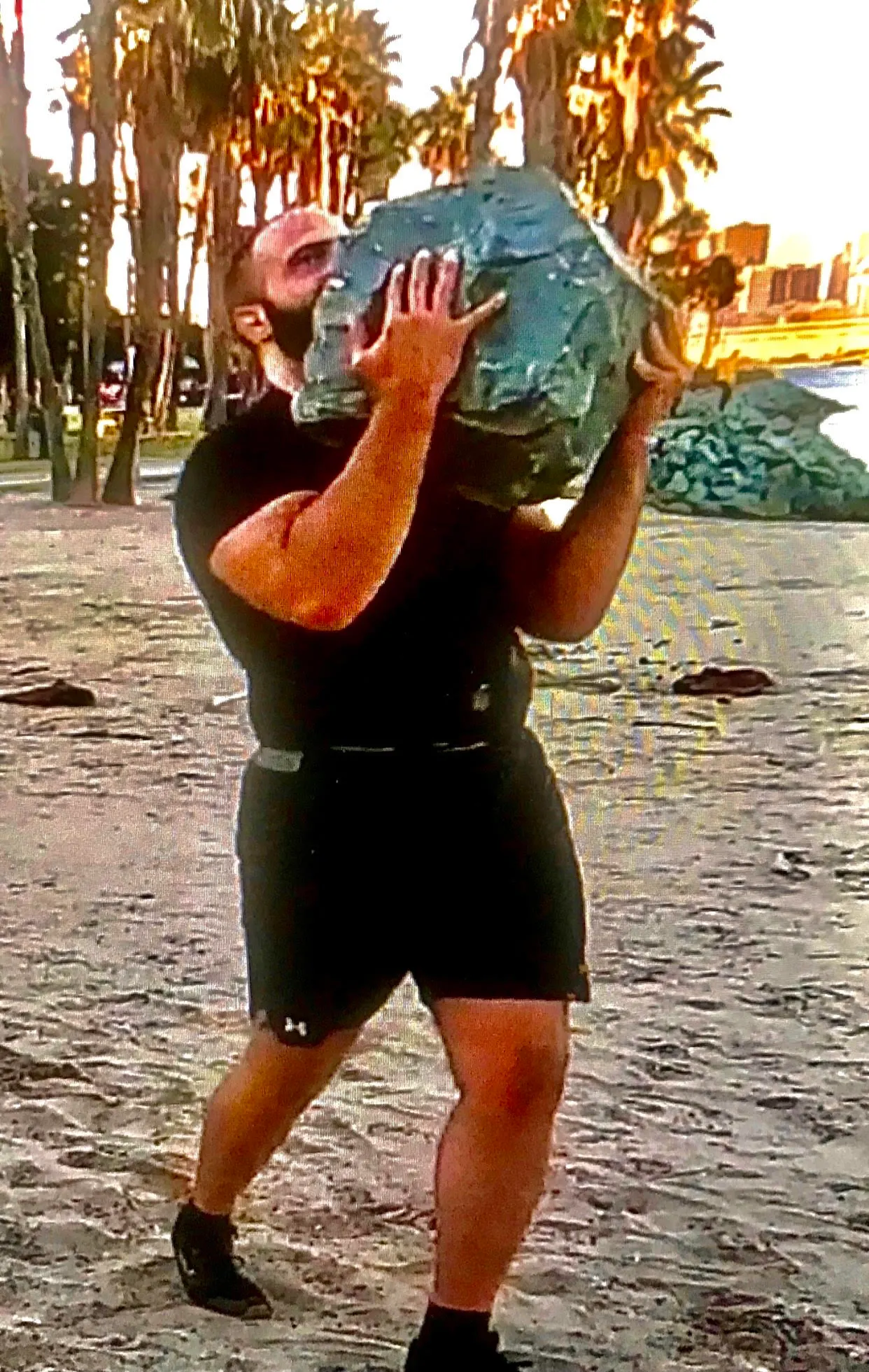 Gabriel carrying a large rock
